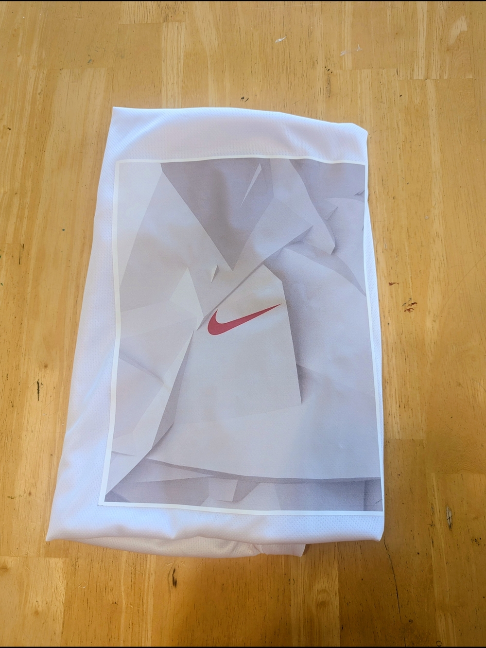Nike White Tee with Pink Swoosh Graphic